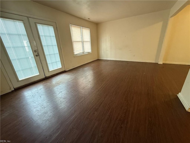 unfurnished room featuring dark hardwood / wood-style floors and french doors