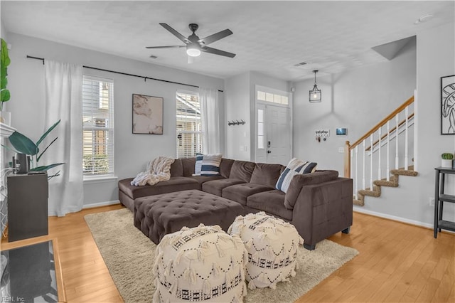 living room featuring ceiling fan and light hardwood / wood-style floors