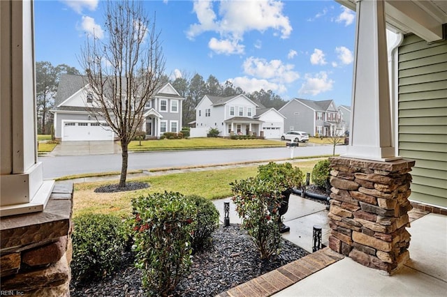 view of yard featuring a porch and a garage