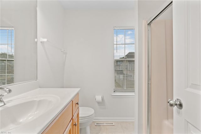 bathroom featuring vanity, an enclosed shower, tile patterned floors, and toilet