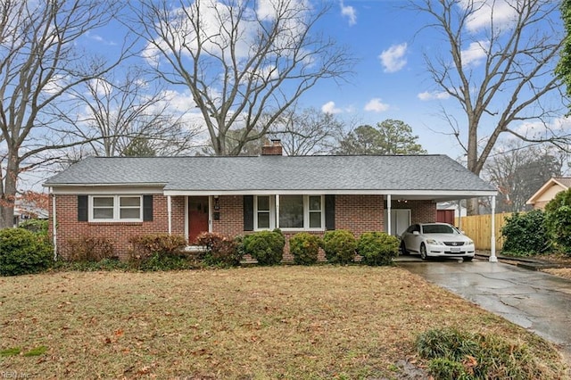 single story home featuring a front lawn and a carport