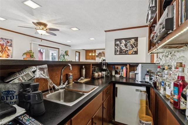 kitchen featuring french doors, sink, crown molding, refrigerator, and ceiling fan