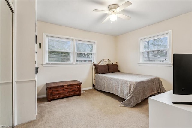 bedroom with light carpet and ceiling fan