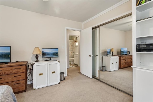 bedroom featuring light colored carpet and a closet