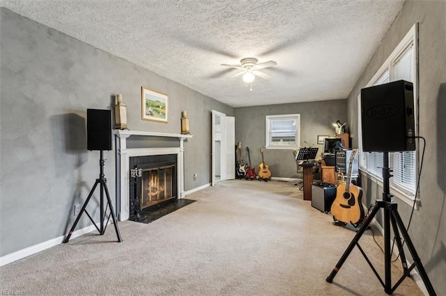 interior space with a textured ceiling, ceiling fan, and carpet