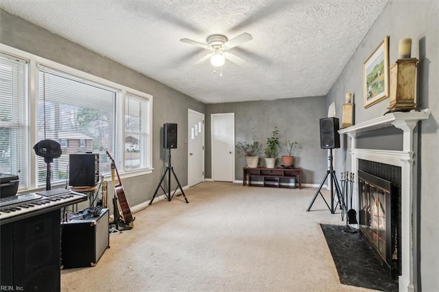 interior space featuring carpet, a textured ceiling, and ceiling fan