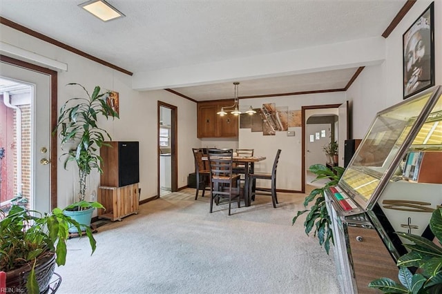 dining room with an inviting chandelier, ornamental molding, light carpet, and a textured ceiling