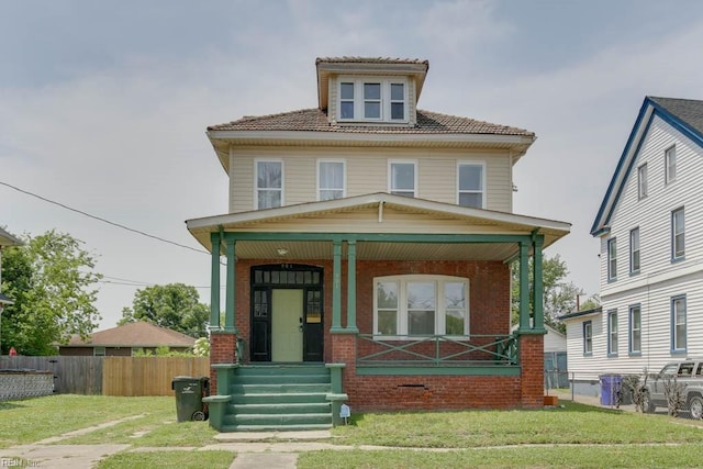 view of front of home featuring covered porch and a front yard