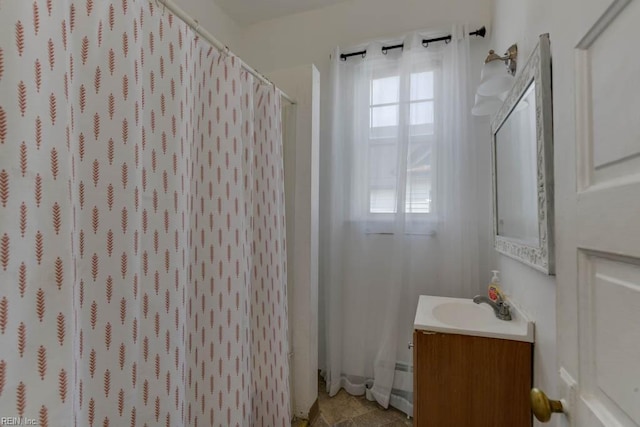 bathroom featuring vanity and curtained shower