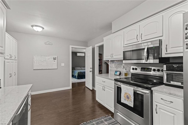 kitchen featuring white cabinetry, appliances with stainless steel finishes, and dark wood-type flooring