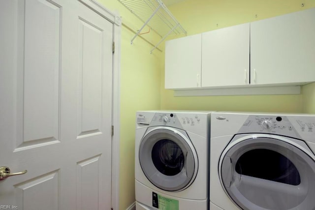 washroom with cabinets and independent washer and dryer