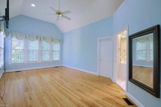 unfurnished room with ceiling fan, light hardwood / wood-style flooring, a healthy amount of sunlight, and vaulted ceiling