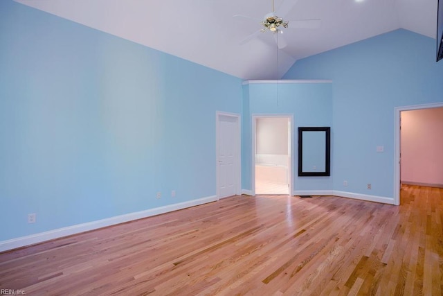 empty room featuring high vaulted ceiling, light hardwood / wood-style floors, and ceiling fan