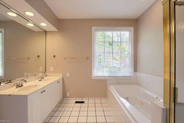 bathroom featuring vanity, a relaxing tiled tub, and tile patterned floors