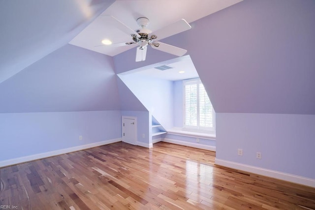 additional living space with vaulted ceiling, ceiling fan, and light hardwood / wood-style flooring