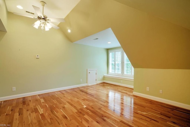 additional living space with ceiling fan, lofted ceiling, and hardwood / wood-style floors