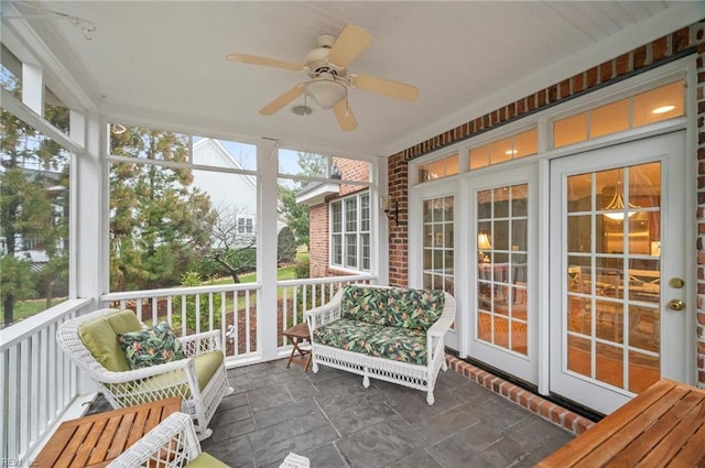 sunroom / solarium featuring a ceiling fan and a wealth of natural light