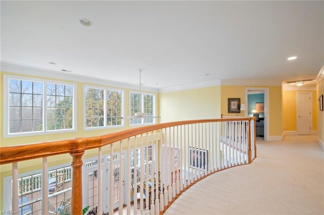 hall featuring light carpet, baseboards, crown molding, and recessed lighting