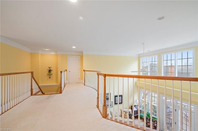 hall with light carpet, recessed lighting, ornamental molding, and an upstairs landing