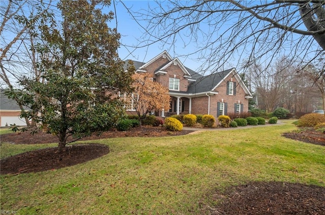 view of front of property featuring brick siding and a front yard