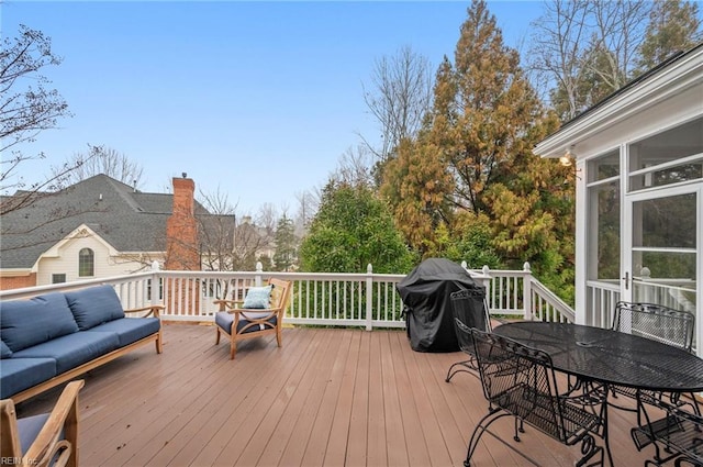 deck featuring a grill, an outdoor living space, and outdoor dining space