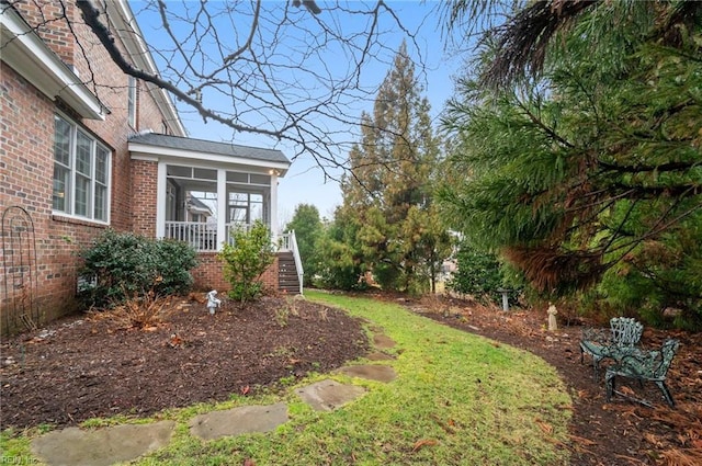 view of yard with a sunroom and stairs