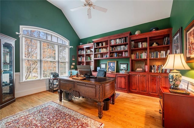 office area featuring light wood-type flooring, vaulted ceiling, baseboards, and ceiling fan