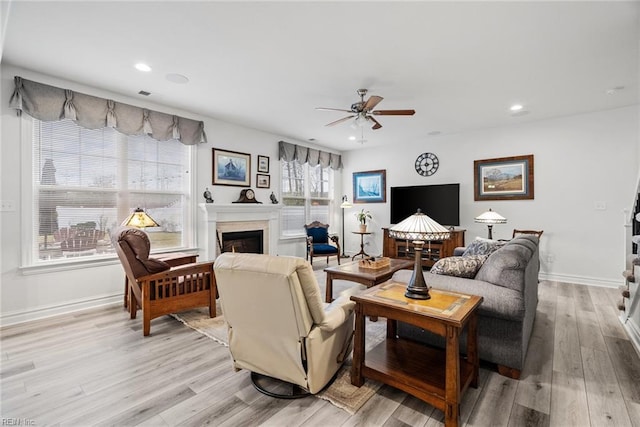 living room featuring ceiling fan and light wood-type flooring