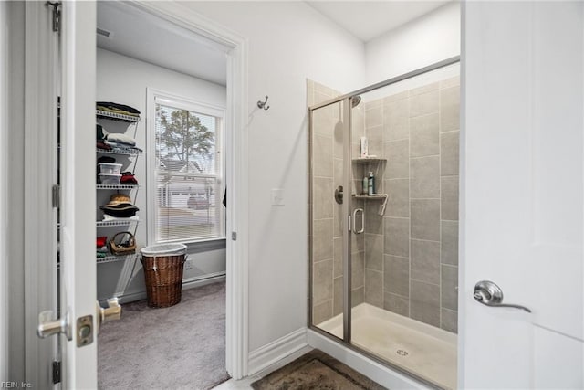 bathroom with a shower with door