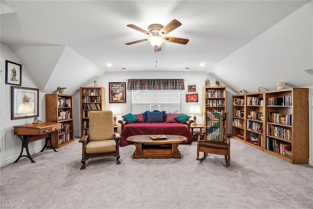 living area with vaulted ceiling, light colored carpet, and ceiling fan