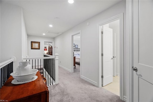 hallway with light colored carpet