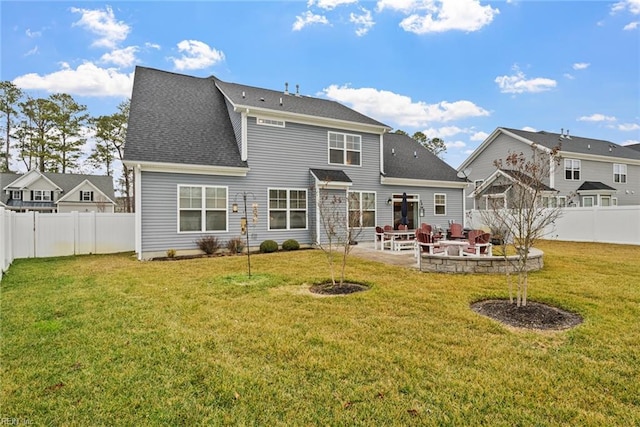 rear view of house featuring a lawn and a patio area