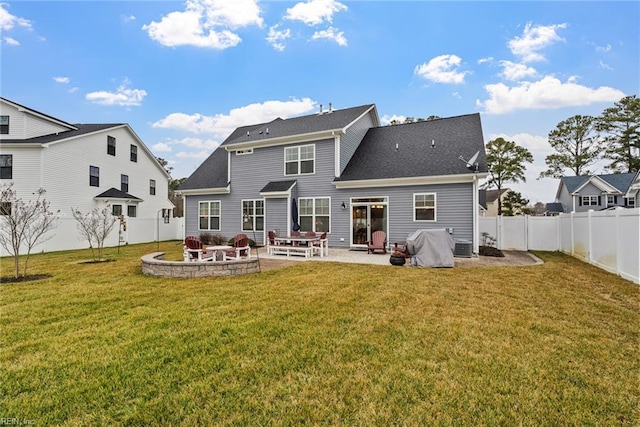 back of house featuring a patio and a yard