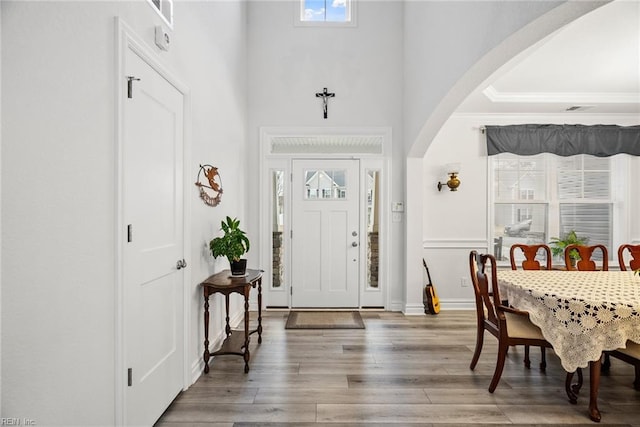 entryway with a towering ceiling and hardwood / wood-style floors