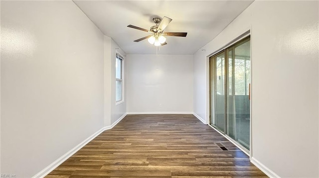 unfurnished room featuring dark wood-type flooring and ceiling fan