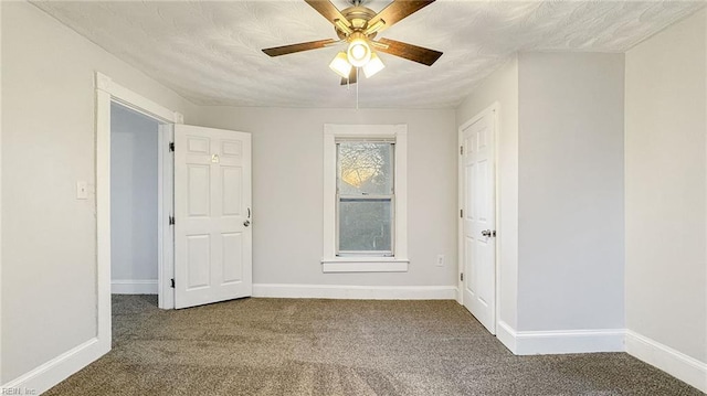 carpeted empty room with ceiling fan