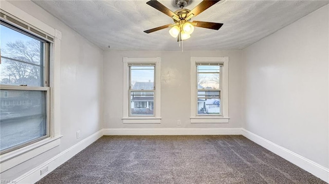 spare room with ceiling fan and carpet flooring