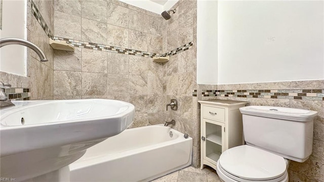 full bathroom with tile walls, sink, toilet, and shower / bath combination