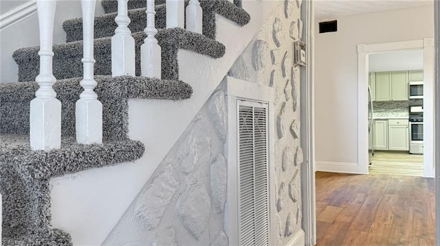 interior details featuring stainless steel appliances and wood-type flooring