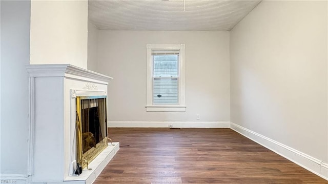 unfurnished living room featuring dark wood-type flooring