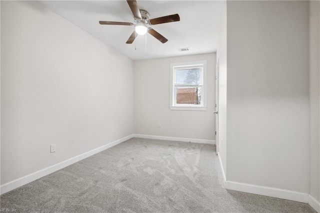 unfurnished room featuring ceiling fan and light carpet