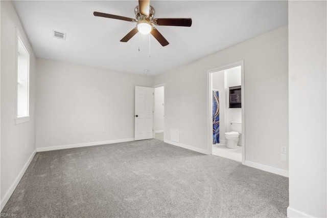 unfurnished bedroom with ceiling fan, connected bathroom, and carpet floors