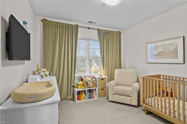 carpeted bedroom with a crib