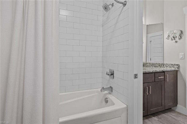bathroom featuring shower / bath combination with curtain, vanity, and hardwood / wood-style floors