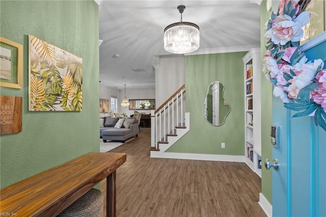 entrance foyer featuring dark wood-type flooring and an inviting chandelier