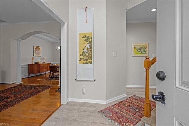 entryway featuring ornamental molding and light wood-type flooring