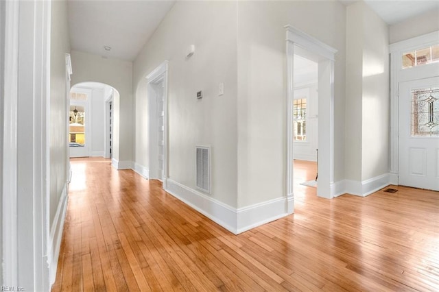 entrance foyer with plenty of natural light and light hardwood / wood-style floors