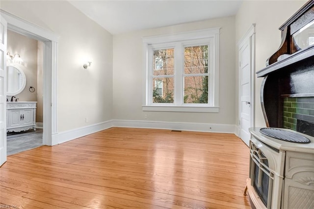 interior space featuring ensuite bathroom and light wood-type flooring