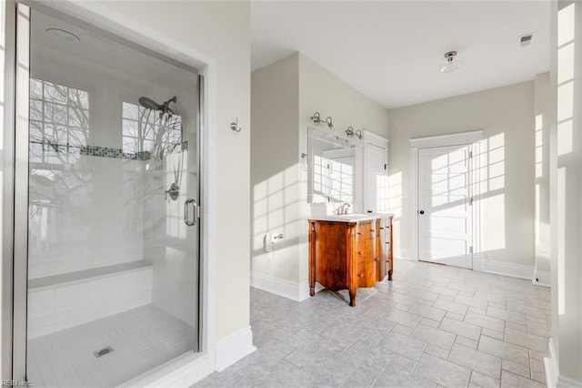 bathroom featuring vanity and a shower with shower door