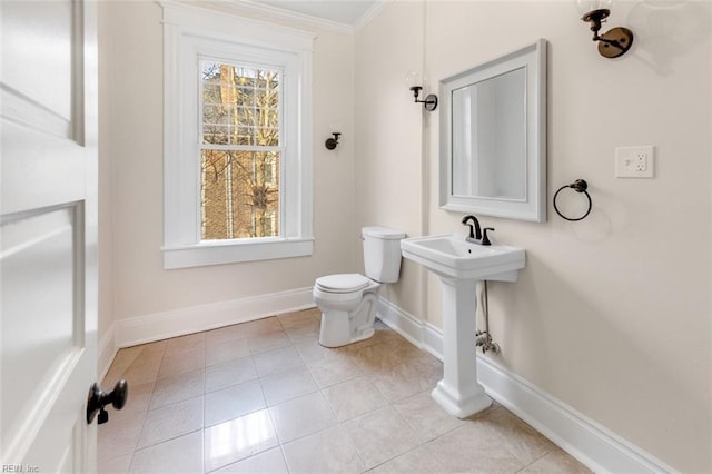 bathroom with tile patterned floors, ornamental molding, and toilet